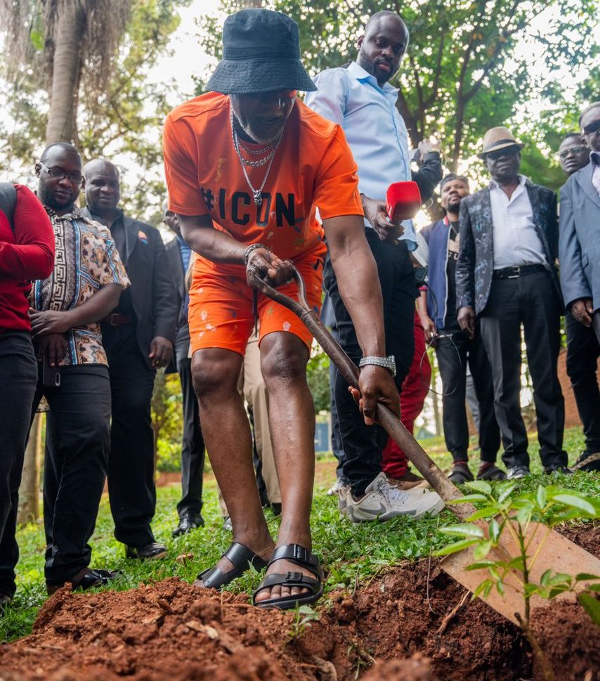 Awilo Longomba planting a tree in Uganda