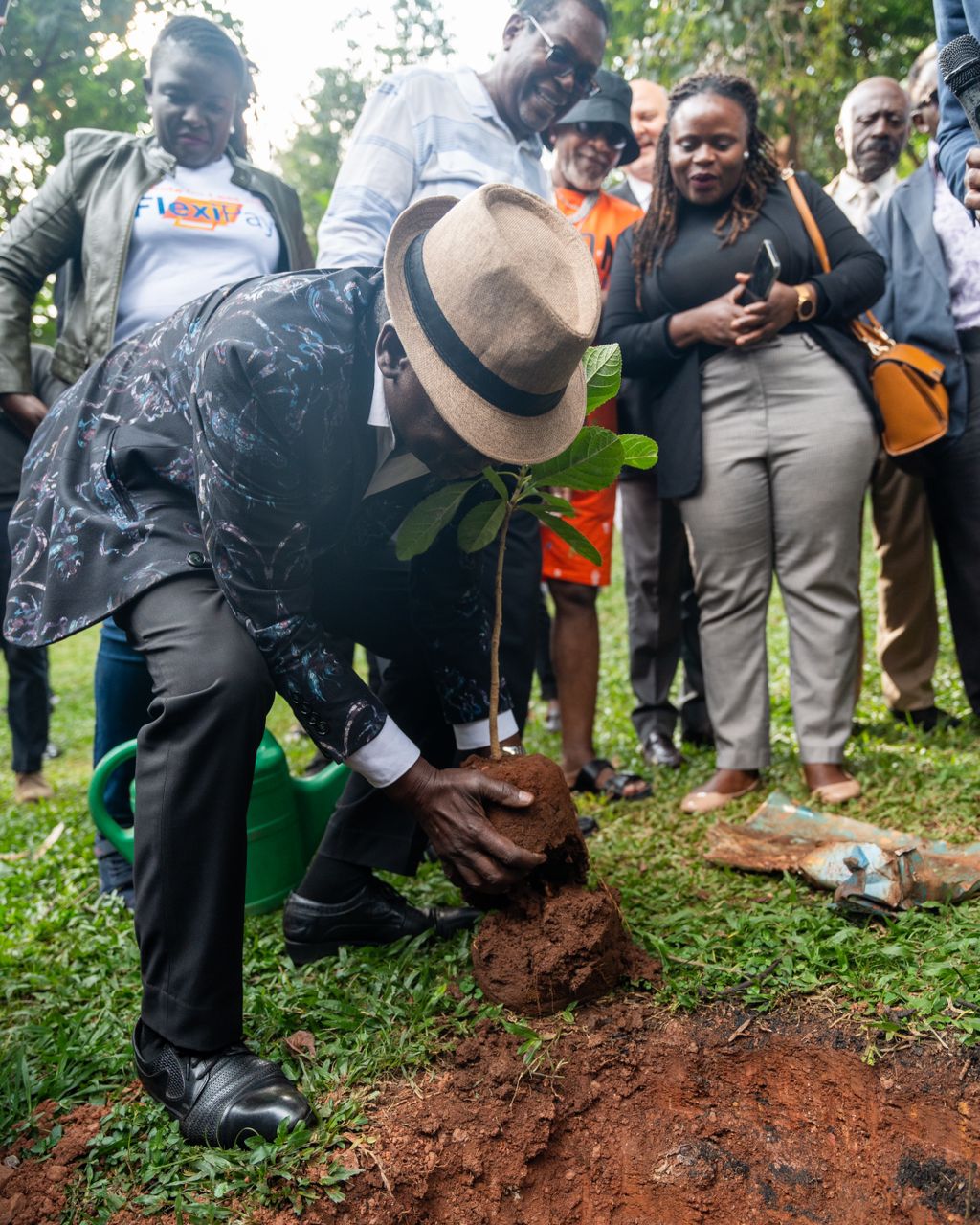 Afrigo Band founder and director Moses Matovu planting a tree